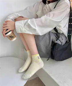Women cotton short socks featuring cute striped design and delicate embroidered letter details.