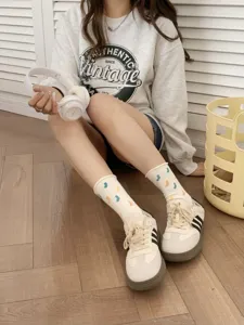 Cute Japanese style white mid-tube stacking socks featuring colorful dot patterns.