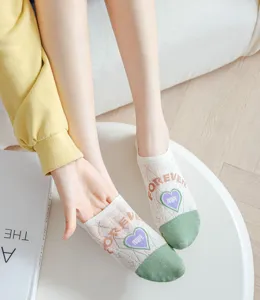 Close-up detail of women shallow low-cut boat socks with cute letters and heart patterns.