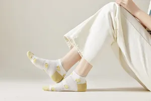 Detail view of women breathable mesh short socks with cute yellow fruit pattern, spring wear.