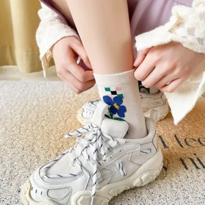 Floral plaid mid-calf socks detail shot showing the cute blue flower pattern and white sneakers.