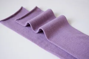 Detail shot of Japanese style purple knit slouch socks showcasing soft fabric texture and rolled cuffs.