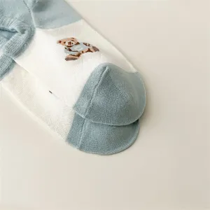 Detail shot of women's short boat socks featuring cute bear pattern and clean white blue design.