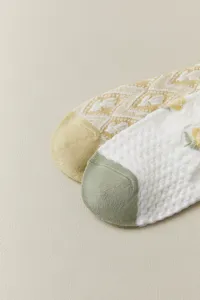 Close-up of breathable mesh ankle socks featuring delicate knit tulip patterns and contrast toes.