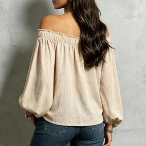 Detailed back view of a stylish off-the-shoulder loose long sleeve blouse in beige.
