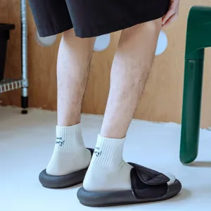 Men's cotton short socks detail view, featuring trendy embroidered text and comfortable design.