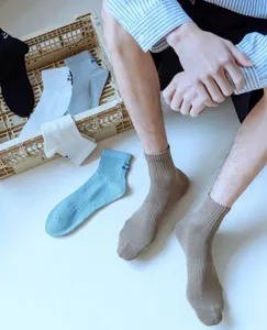 Men's cotton casual mid-calf socks detailed with retro stripes and delicate side embroidery.