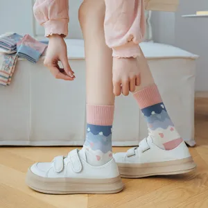 Cute pink and blue women's mid-calf socks with wave and heart patterns, detail view.