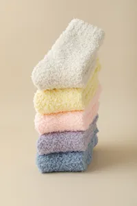Cozy coral fleece fuzzy sleep socks in assorted pastel colors, thick plush floor socks for women.