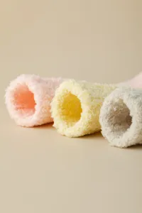 Close-up detail shot of soft fuzzy coral fleece women's sleep socks in candy colors.