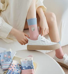 Detailed view of cute pink and blue mid-tube socks featuring elegant tulip embroidery.