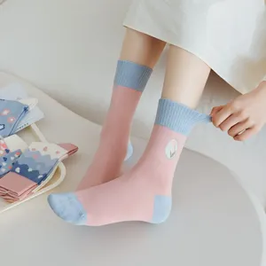 Comfortable women's mid-calf socks featuring sweet tulip embroidery in pink and blue color block.
