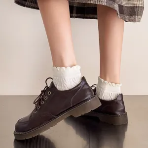 Detail view of Japanese style women short socks with frilly lettuce edge and cute cable knit.