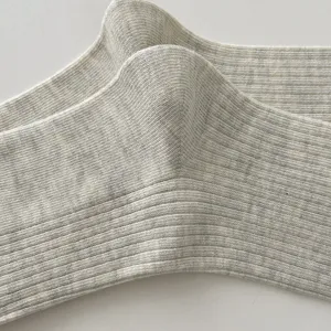 Close-up detail of light grey ribbed knit mid-tube slouch socks, soft breathable texture.