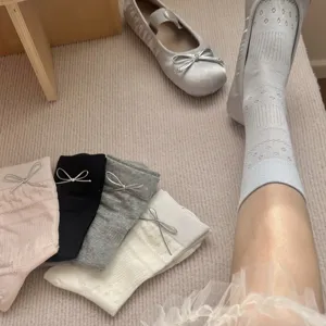 Women's spring summer bow mesh mid-tube socks paired with silver Mary Jane shoes detail.
