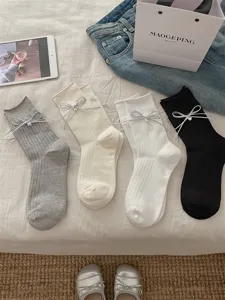 Women's ribbed mid-tube socks with silver bow charm, cute casual hosiery in grey white black.