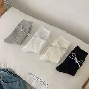 Women bowknot mid-calf socks detailed view, showcasing soft ribbed knit texture and cute silver bow.