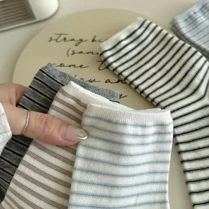 Detailed shot of comfortable striped mid-tube socks in multi-colors, soft knit fabric.