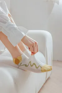 Detail shot of women summer mesh boat socks featuring cute yellow toe and green tulip pattern.