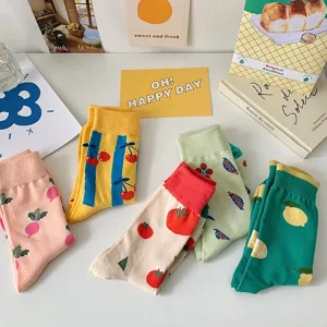 Colorful fruit and vegetable pattern cute women mid-tube socks detail flat lay view.