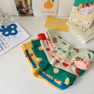 Close-up detail view of cute fruit print mid tube socks featuring cherry and lemon patterns.
