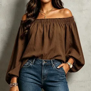 Close-up detail of the elegant off-the-shoulder brown long sleeve top with textured fabric.