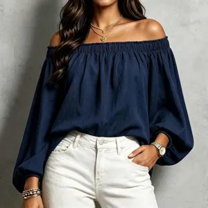 Detailed view of the navy blue off-the-shoulder long sleeve top, elastic neckline.