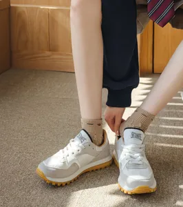 Detailed shot of cute patterned socks paired with retro sneakers, comfortable everyday style.