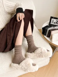 Cozy wool ribbed socks detail, soft warm winter cashmere socks showcased in a cozy room setting.