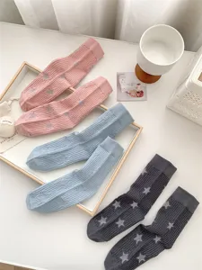 Detail shot of women summer mid tube socks featuring star pattern and ribbed elastic cuff.