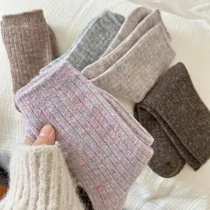 Close-up of cozy thick knit wool blend socks in various autumn and winter pastel colors.