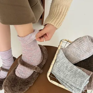 Cozy knit wool blend crew socks detail shot, thick warm winter thermal hosiery for women.
