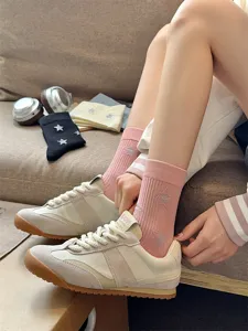 Women's mid-calf socks featuring cute star patterns paired with stylish vintage sneakers.