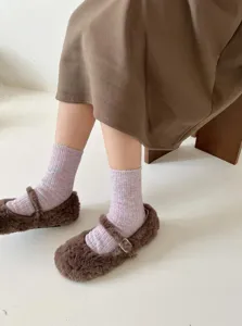 Detailed view of women's thick warm knit wool socks in soft marled pink, cozy texture.