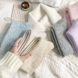Close-up detail of soft wool knit thick warm winter slouch socks in multiple cozy colors.