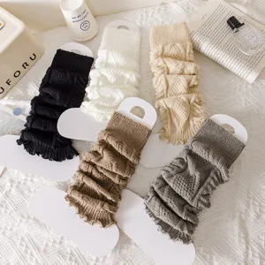 Cozy knit leg warmers in various colors displayed neatly for winter fashion outfit styling.