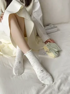 White cotton slouch socks featuring sweet bow embroidery, lace ruffle trim, and delicate details.