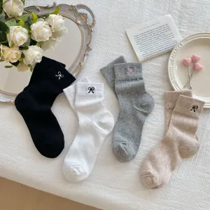 Detailed view of women's bow embroidered mid-tube socks in black, white, grey, and khaki colors.