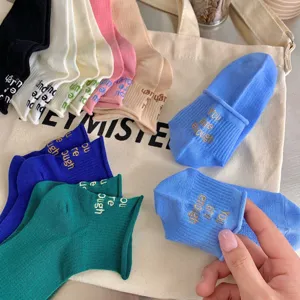 Women's multi-color cotton socks with embroidered quotes and cute ruffled trim details.