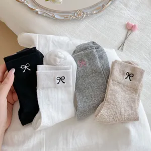 Close-up details of women cute bow embroidery slouch socks in multi colors aesthetic style.
