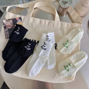 Detailed view of stylish Japanese ribbed short socks with lovely letter embroidery design.