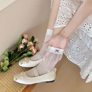 White mesh slouch socks with cute black bow embroidery, perfect for sweet ballet style outfits.