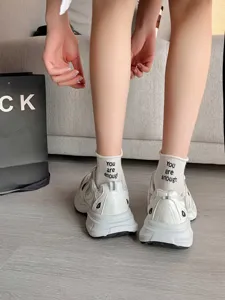 Comfortable women's short socks paired with stylish white casual sneakers for daily wear.