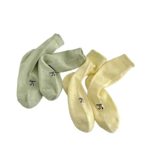 Spring summer women pointelle crew socks with cute bow embroidery, breathable mesh design.