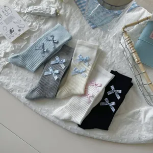 Detailed view of women's Japanese style stackable ribbed socks featuring cute plaid bow knots.