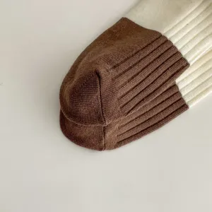 Detailed view of women's contrast color ribbed knit socks showing heel and texture.