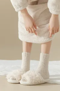Cozy thickened coral velvet sleep socks in soft beige, fluffy texture, warm indoor wear.