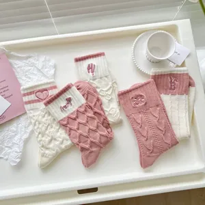 Cute embroidered mid-calf socks for women, sweet pink and white cable knit design for spring.