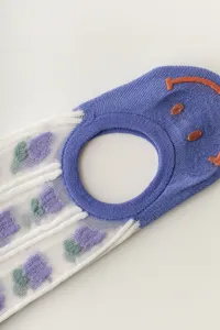 Close-up detail of women's breathable mesh boat socks with 3D smiley anti-slip grip.