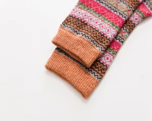 Close-up detail view of vintage ethnic style wool socks with colorful geometric knit patterns.